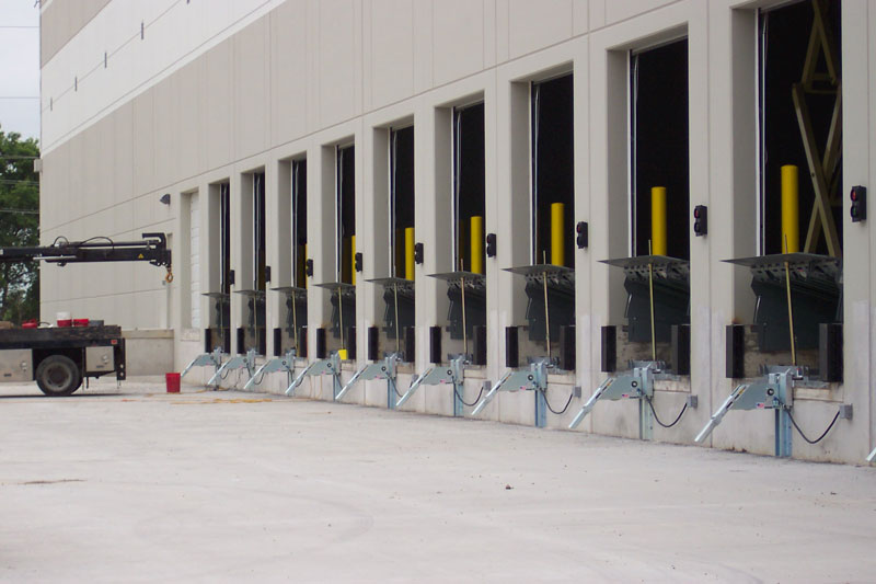 A long row of shipping docks on the side of a warehouse for 3M corporations.