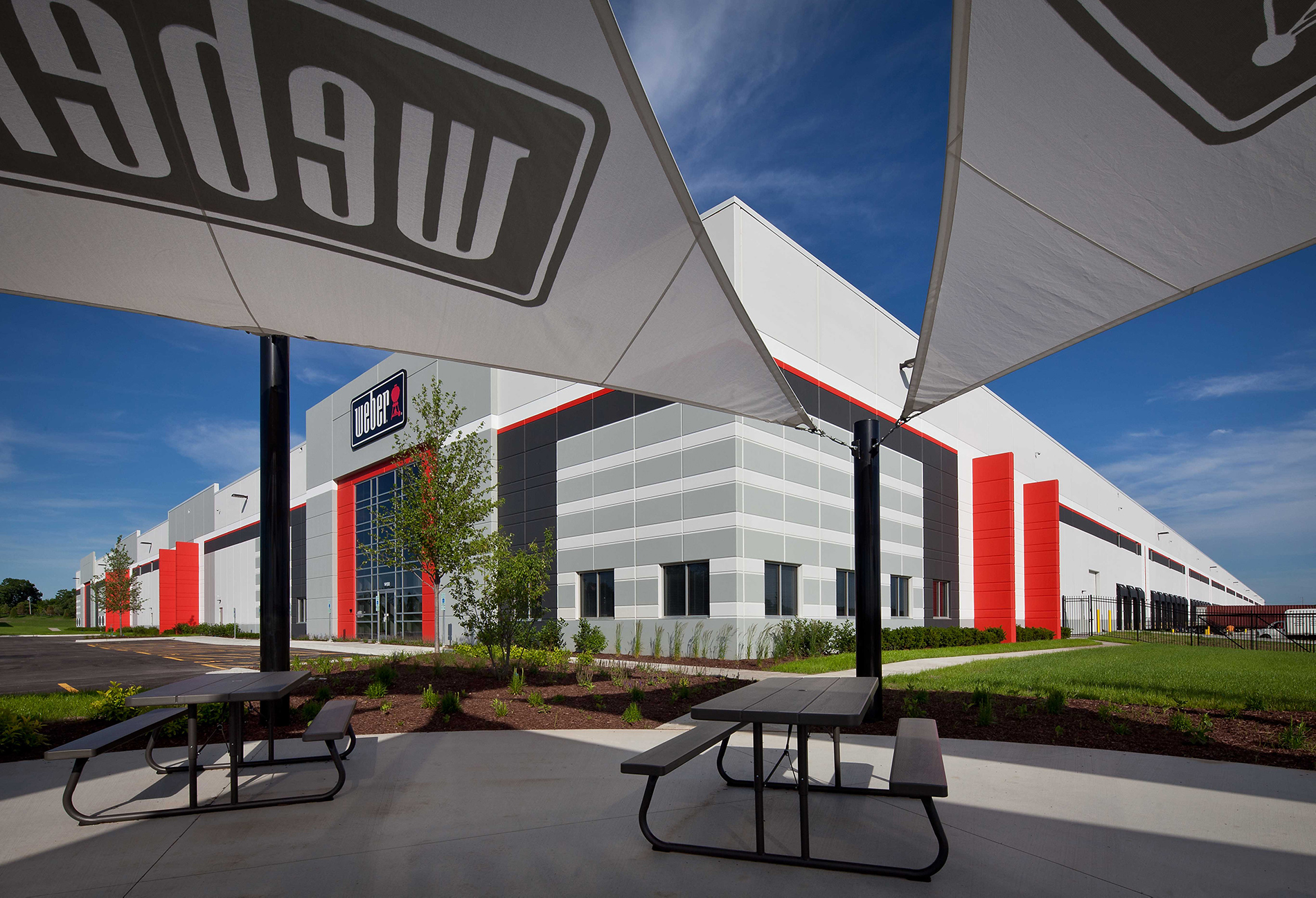 A fish-eye view of the Weber facility from the covered outdoor gathering space, complete with picnic tables.