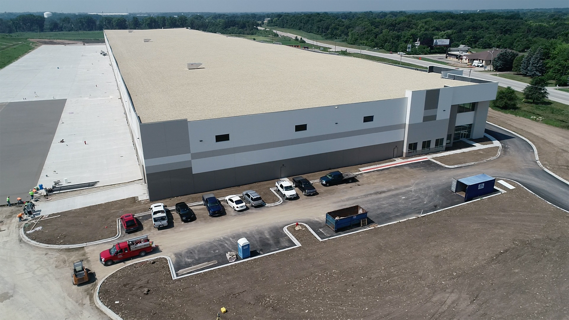 An aerial view of a corporate distribution center, the shipping and receiving area, and the employee parking lot.