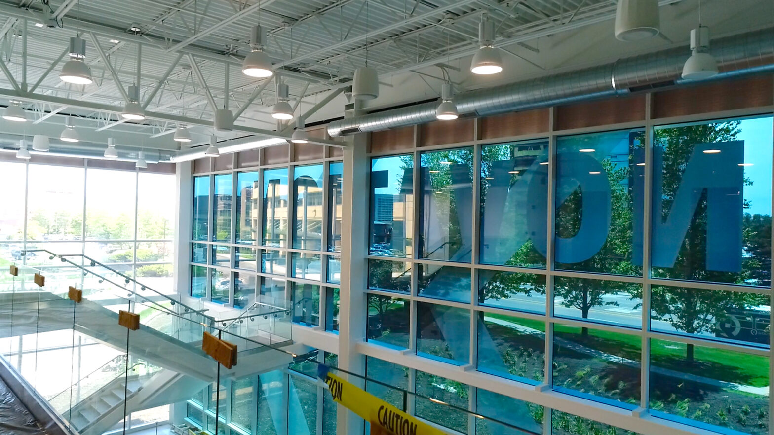 Inside a large glass building looking outward.