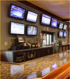 A new bar with multiple state-of-the-art monitors on the wall facing the customers, built by Keeley Construction, Inc., for Crazy Pour.