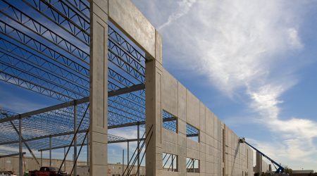 The skeleton of Kuehne & Nagel's 179,000 square foot building stands tall against a bright blue sky as construction continued by Keeley Construction, Inc.